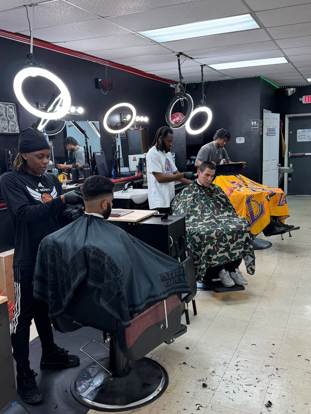 Barbers on the floor during a busy day at Polished Gents